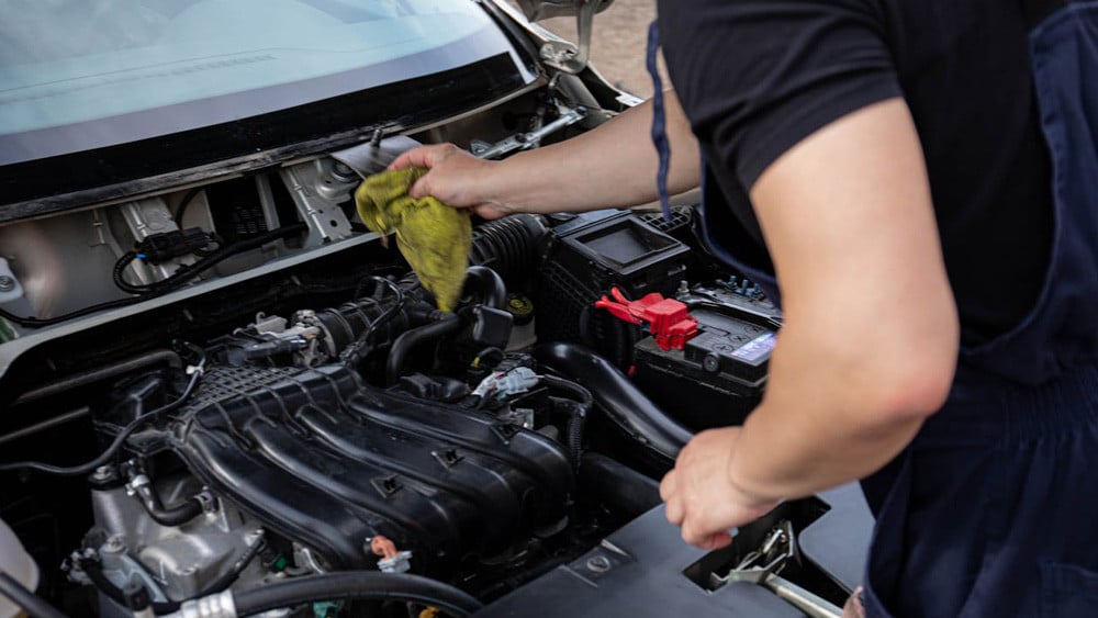 man cleaning the engine