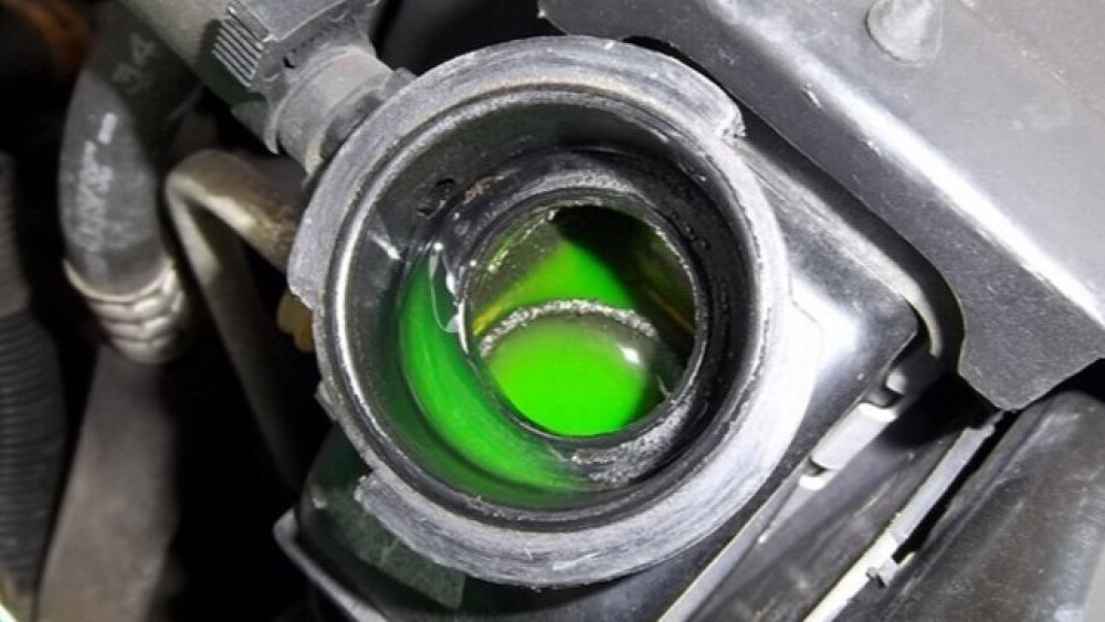 Green antifreeze sitting in the top of a radiator