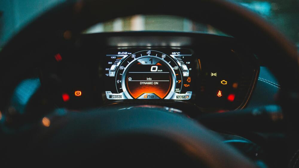 Car dashboard with illuminated check engine light