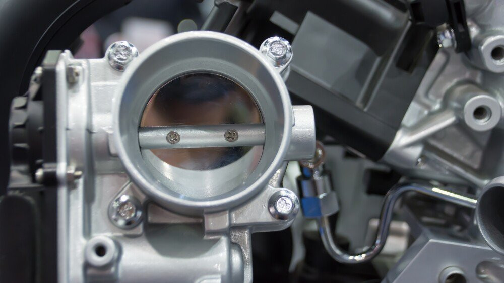 The closed up of throttle body and engine
