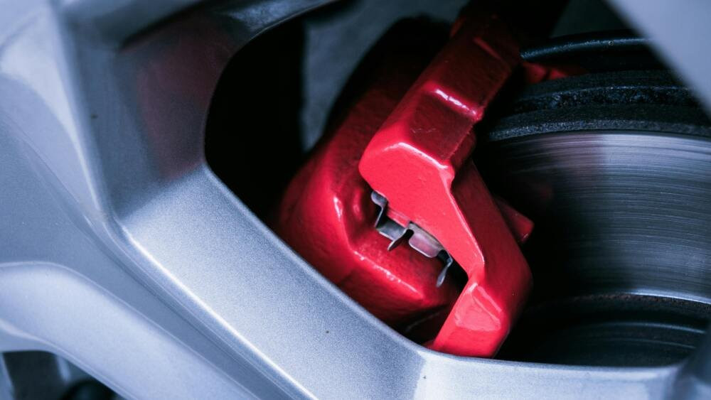 Zoomed in image of a red brake caliper