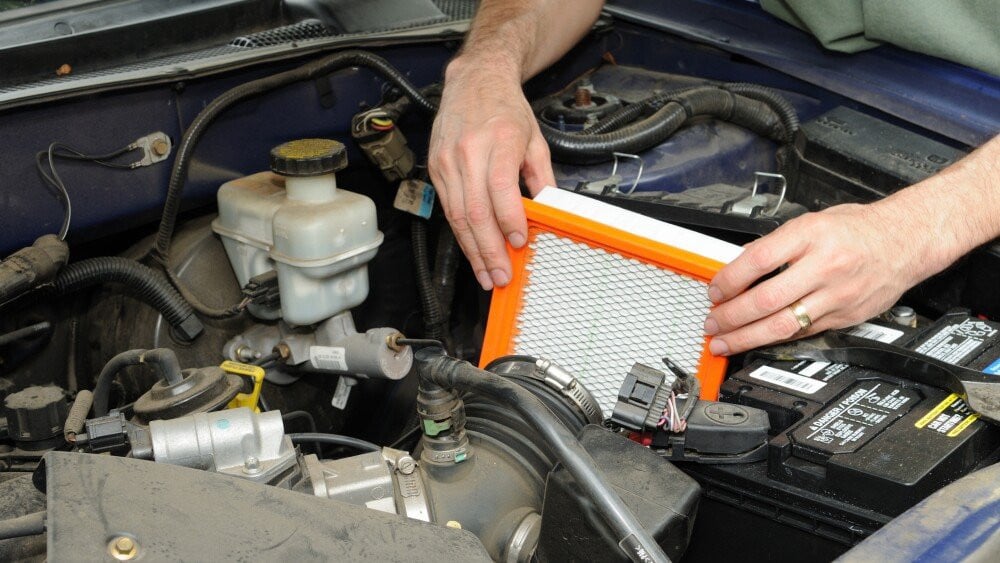 Man replacing an automotive air filter