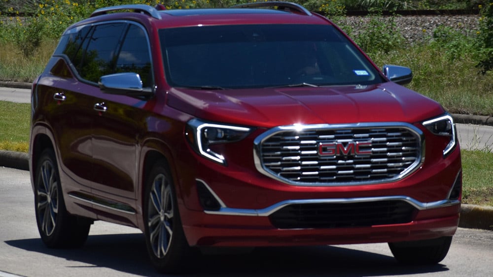 red gmc acadia on the road