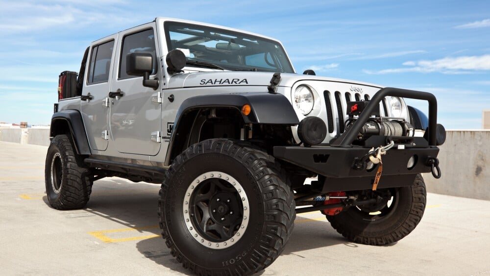 Scottsdale, United States - November 10, 2011: A parked silver 2008 Jeep Wrangler, this particular Jeep has a custom shock kit and winch and is known as the Sahara edition.