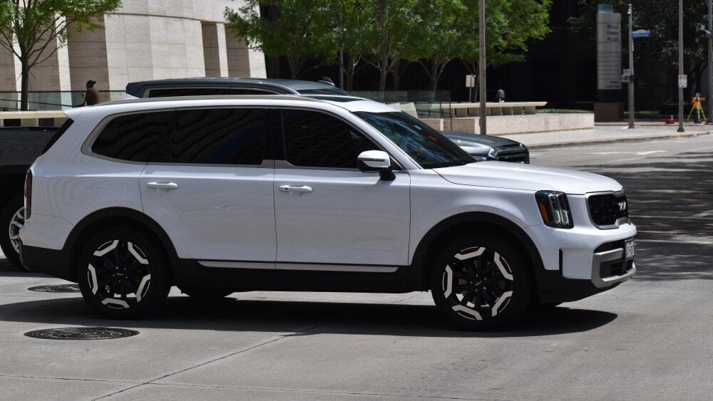 Houston, TX USA - A portrait of a white Kia Telluride SX SUV cruising in a downtown district