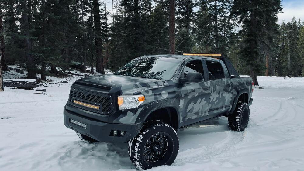 Pickup truck with lift kit driving in snow