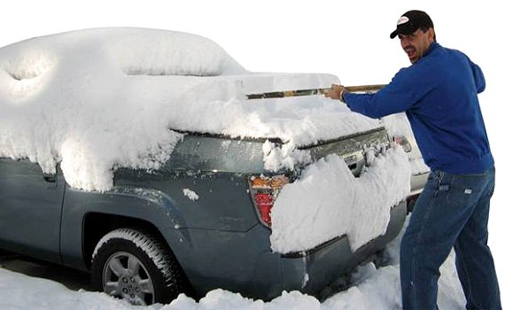 Man Cleaning Truck From Snow