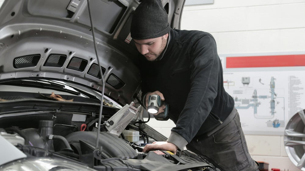 man checking engine