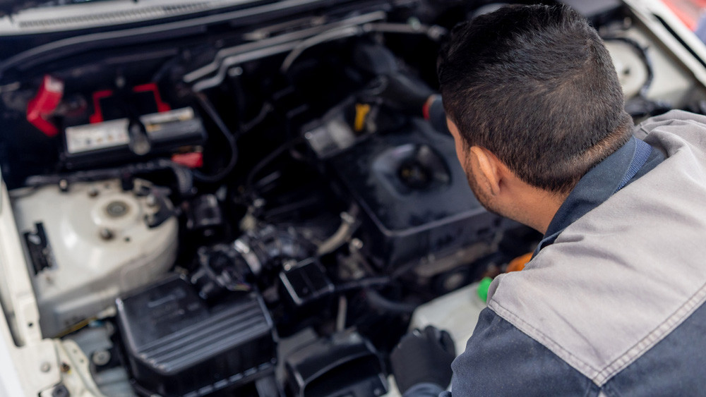mechanic checking under the hood