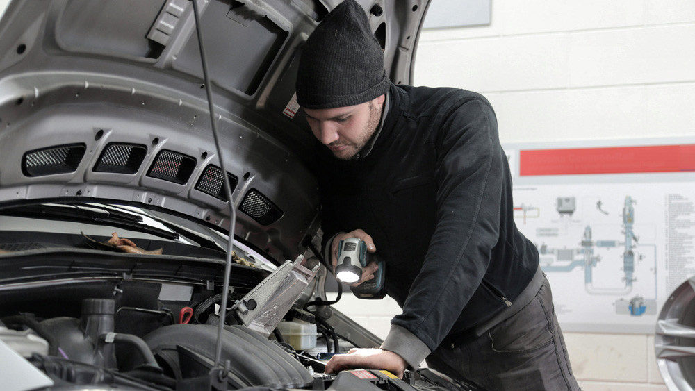 Mechanic inspecting engine