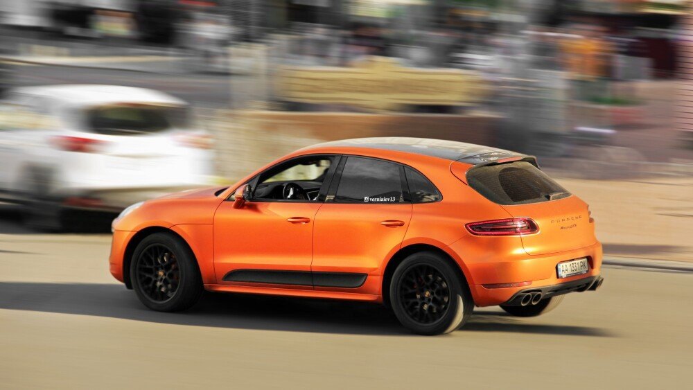 Kiev, Ukraine - May 22, 2021: Matte orange Porsche Macan GTS on the road in motion