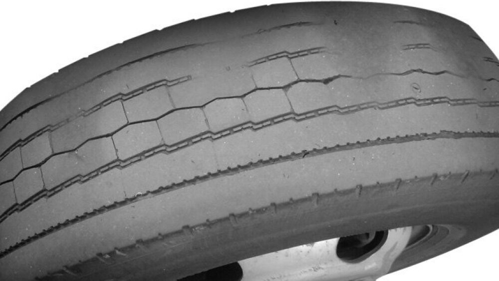 Tire wear known as cupping that indicates failed shock absorbers