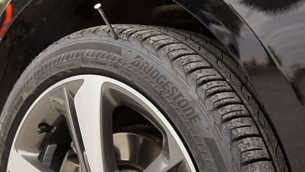 Nail lodged in tire tread tire puncture