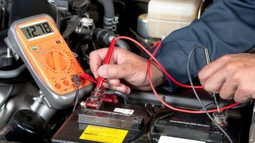 A technician measuring a battery