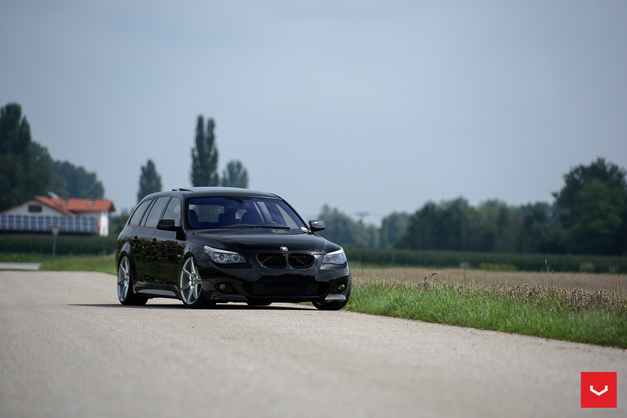 Black BMW 5-Series with Aftermarket Side Skirts - Photo by Vossen