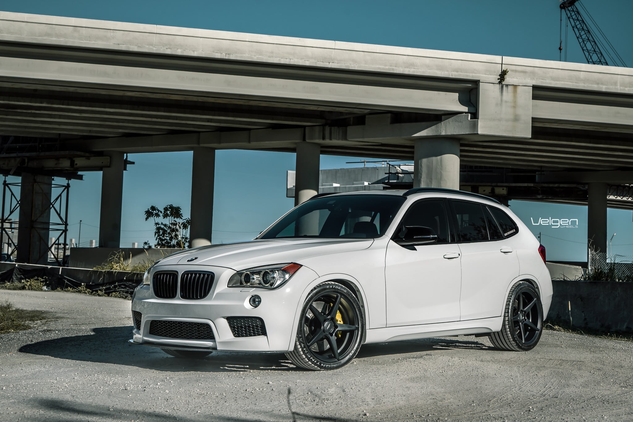 White BMW X1 with Carbon Fiber Front Lip - Photo by Velgen