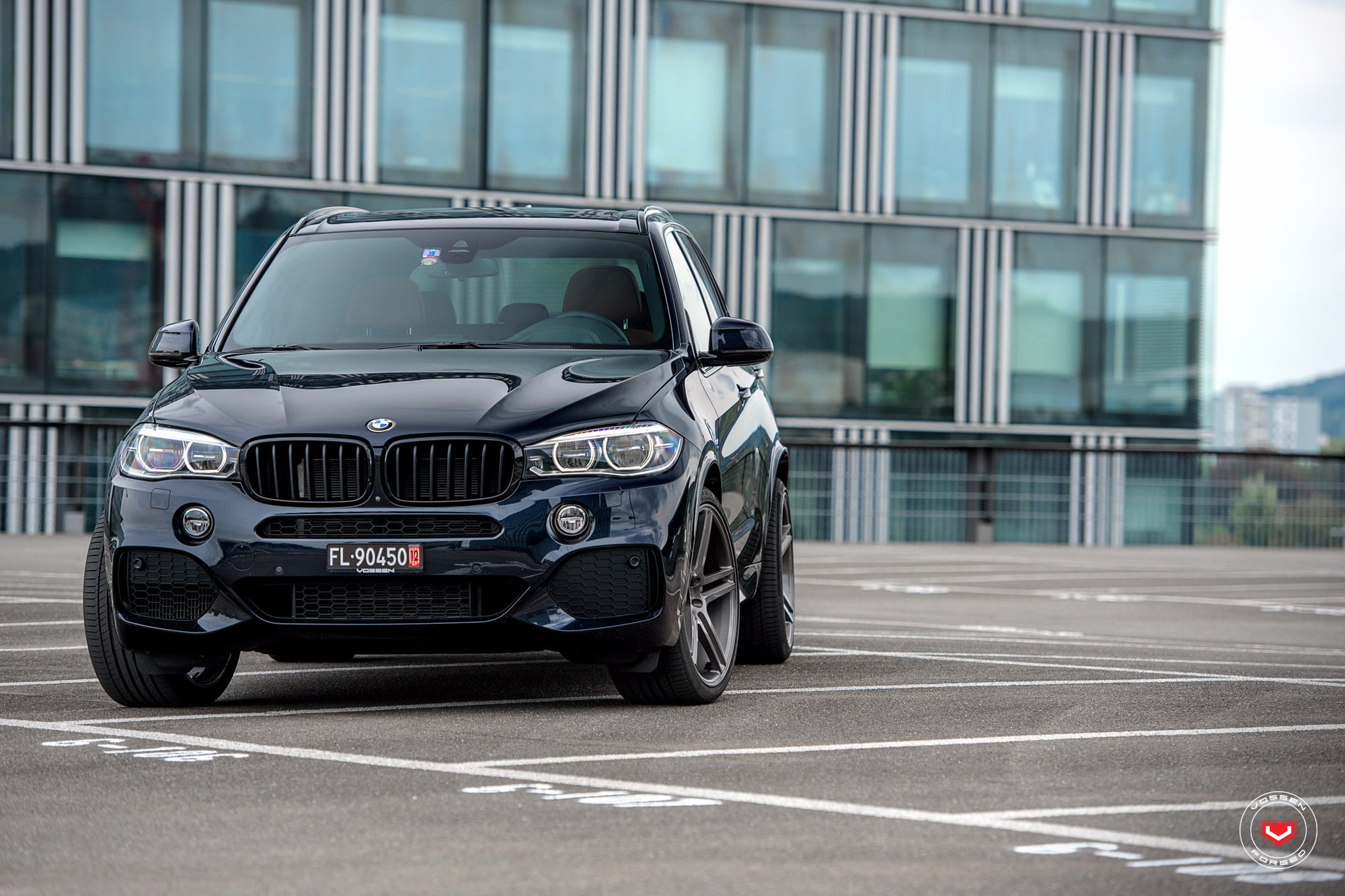 Black BMW X5 with Custom Front Bumper Cover - Photo by Vossen