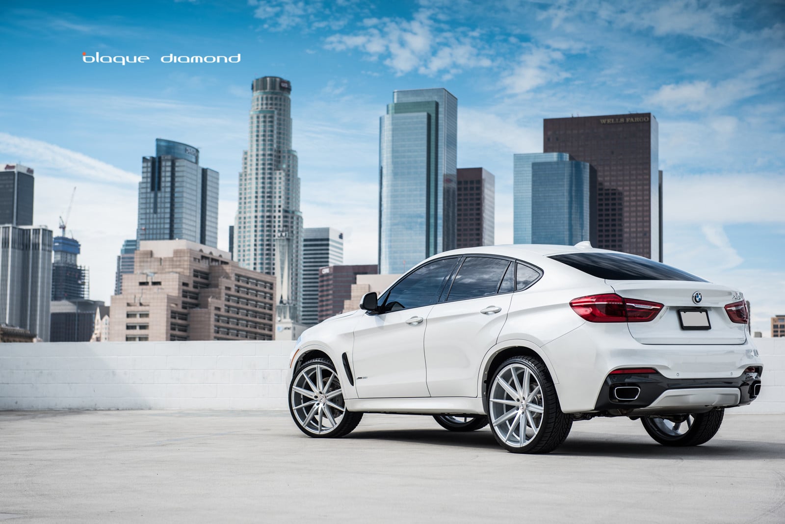 White BMW X6 with Aftermarket Rear Bumper Guard - Photo by Blaque Diamond