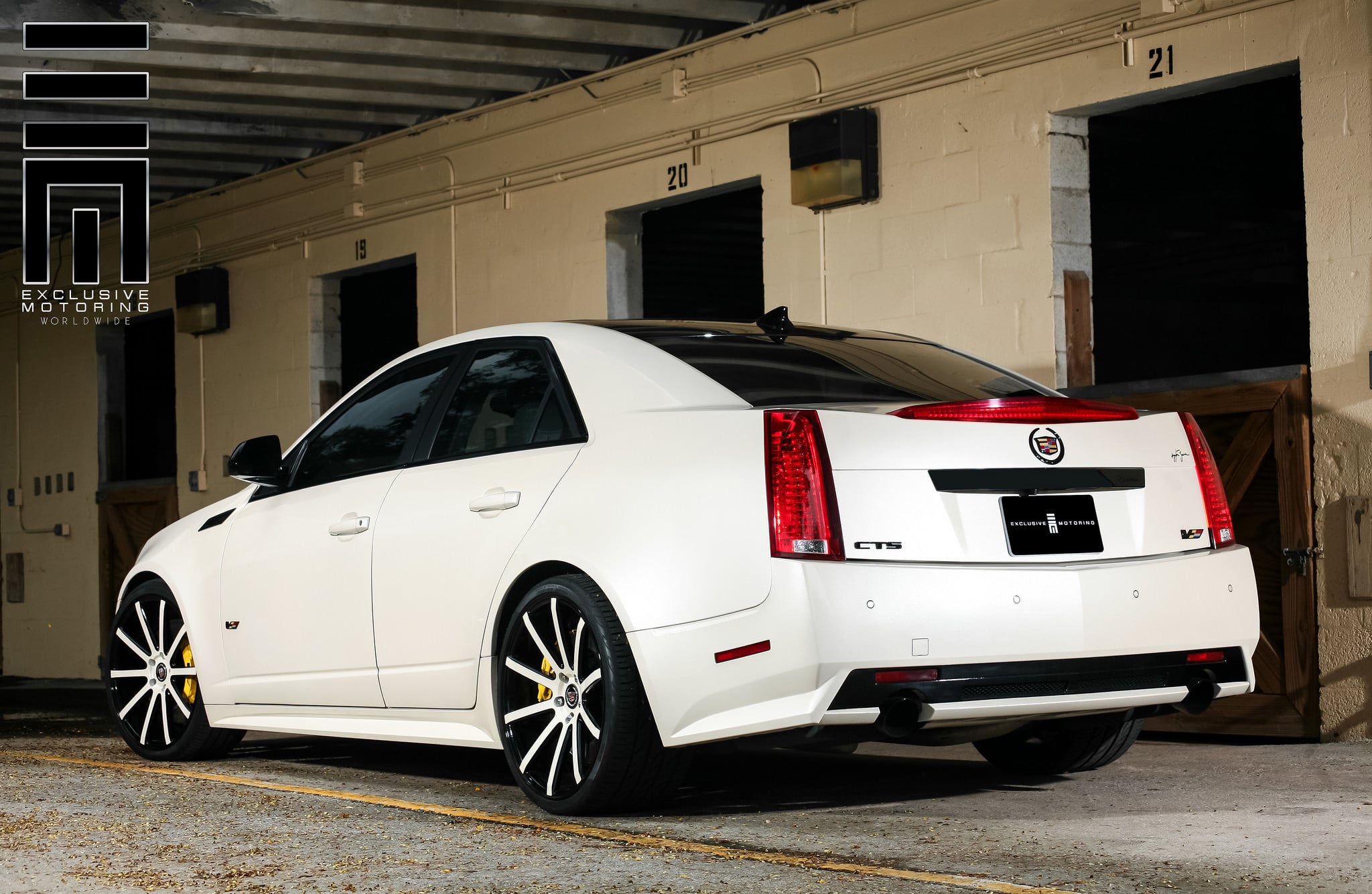White Cadillac CTS-V on custom wheels with yellow brake caliper - Photo by Exclusive Motoring