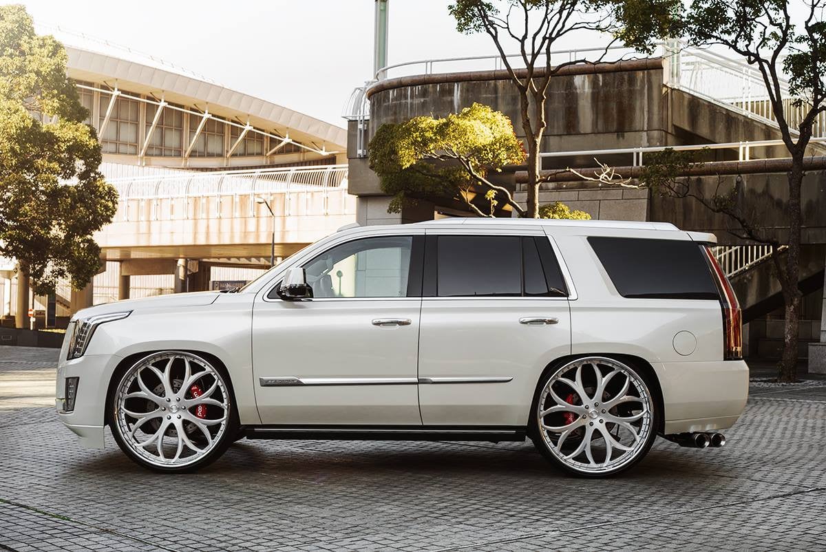 White Cadillac Escalade with Aftermarket Running Boards  - Photo by Lexani