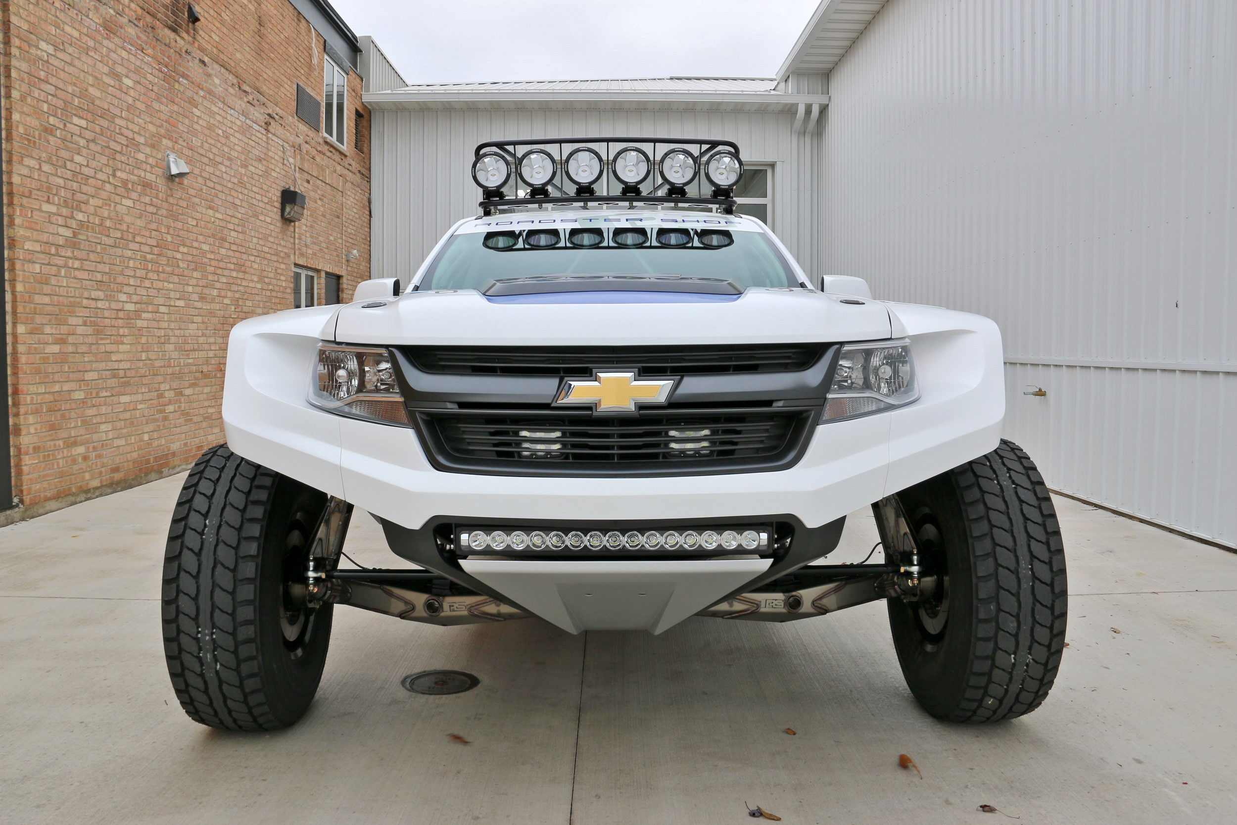 White Lifted Chevy Colorado with Aftermarket Front Bumper - Photo by Roadster Shop