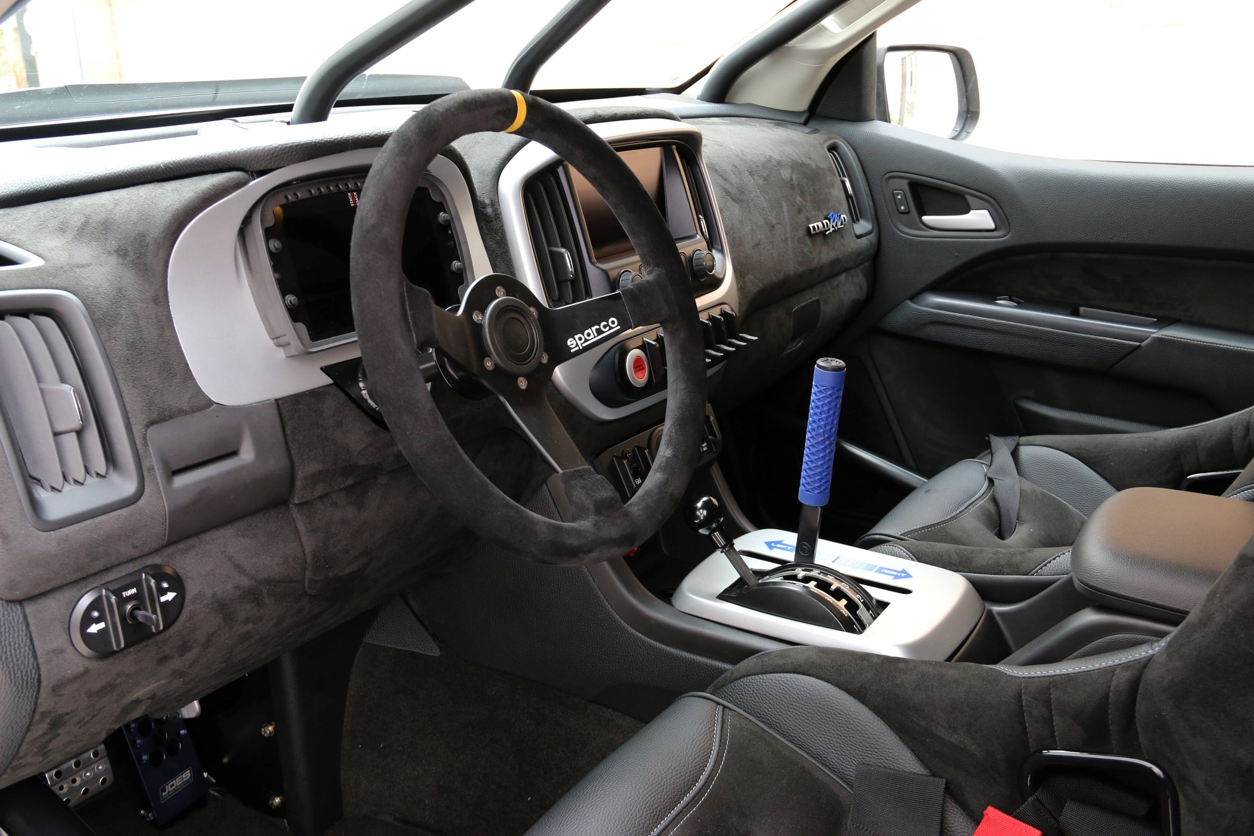 Sparco Steering Wheel in White Lifted Chevy Colorado - Photo by Roadster Shop