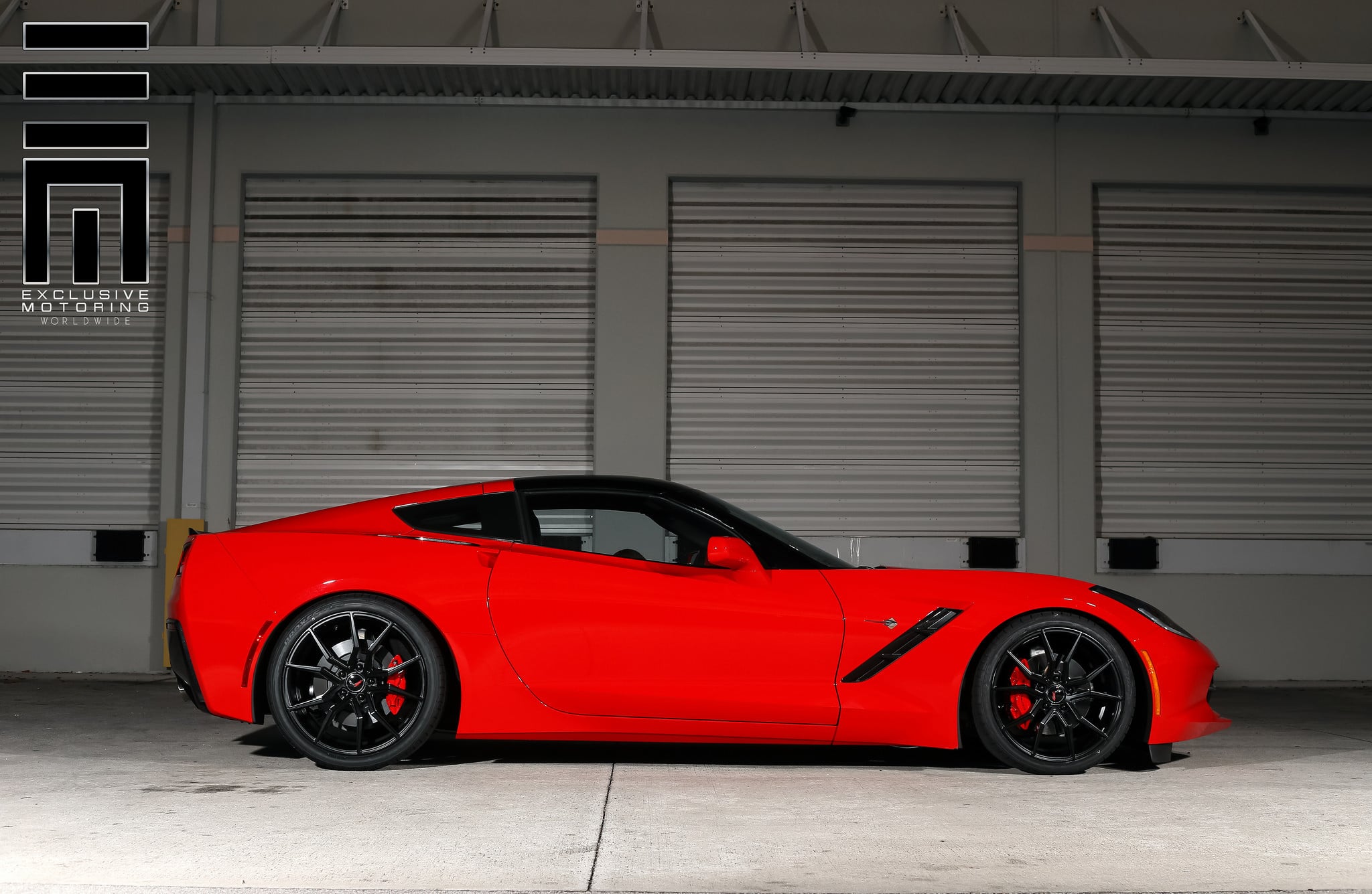 Candy Red Corvette C7 on black wheels with matching red caliper cover - Photo by Exclusive Motoring
