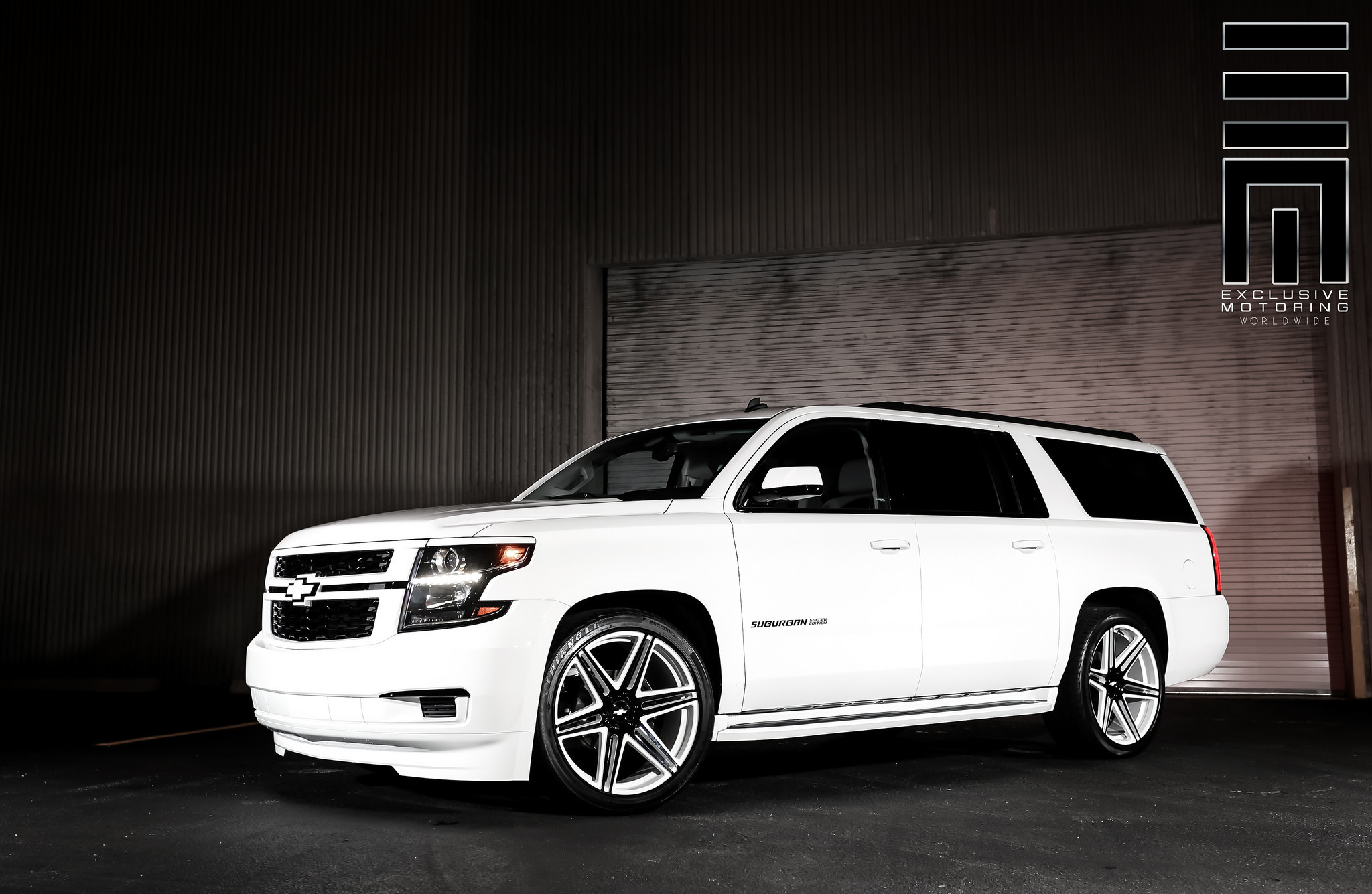 White Iceberg Chevy Suburban on custom colored rims - Photo by Exclusive Motoring