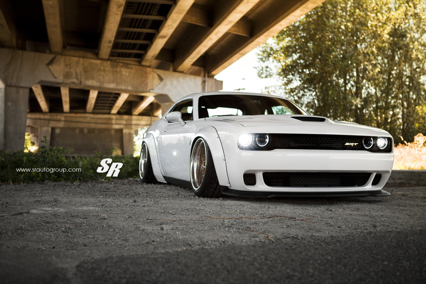 White Dodge Challenger SRT Hellcat flushed to the ground - Photo by SR Auto Group