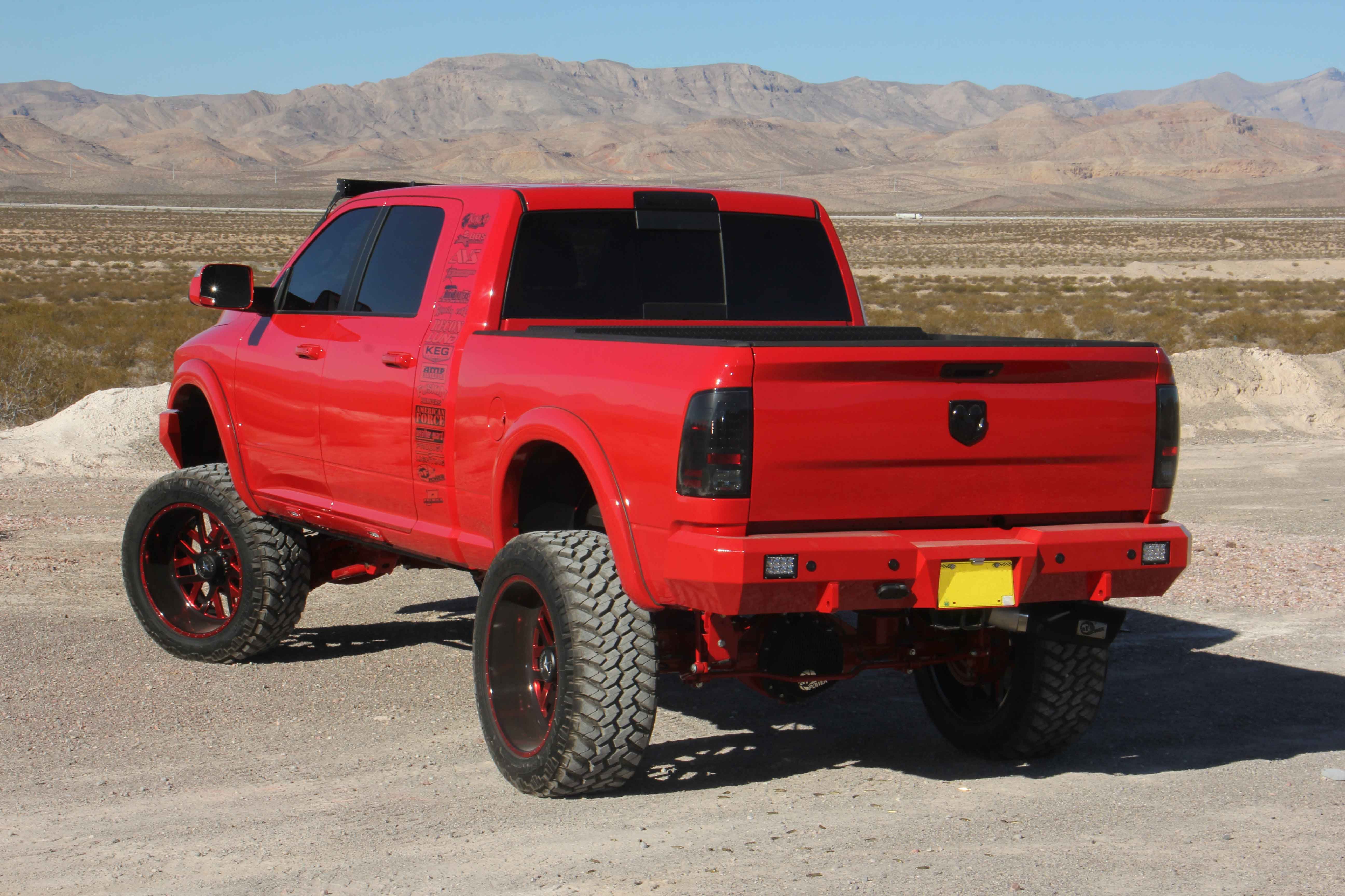 Red Dodge Ram lifted truck - Photo by American Force