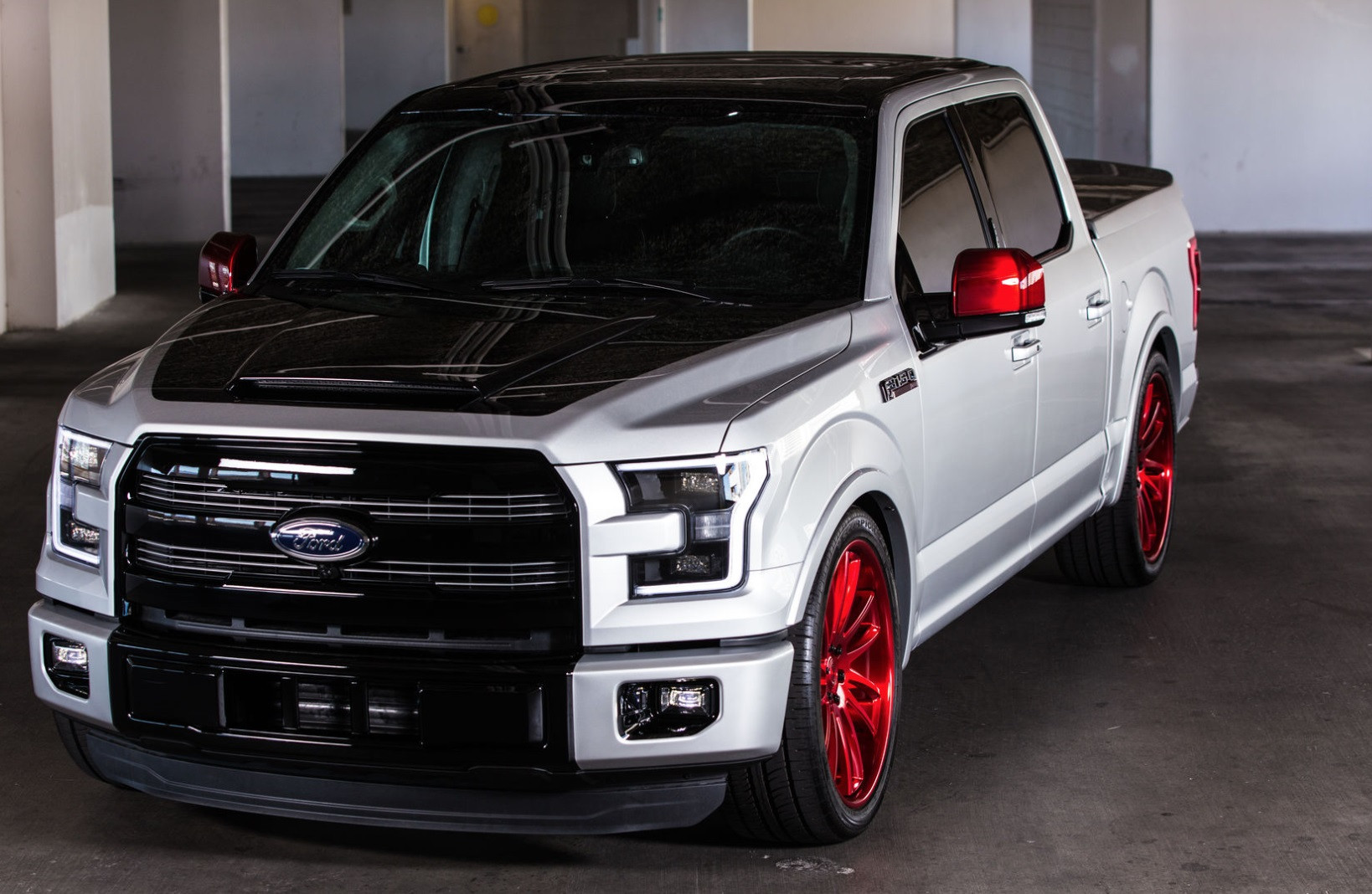 Lowered Black Top Ford F150 on Red Custom Wheels - Photo by CGS Performance