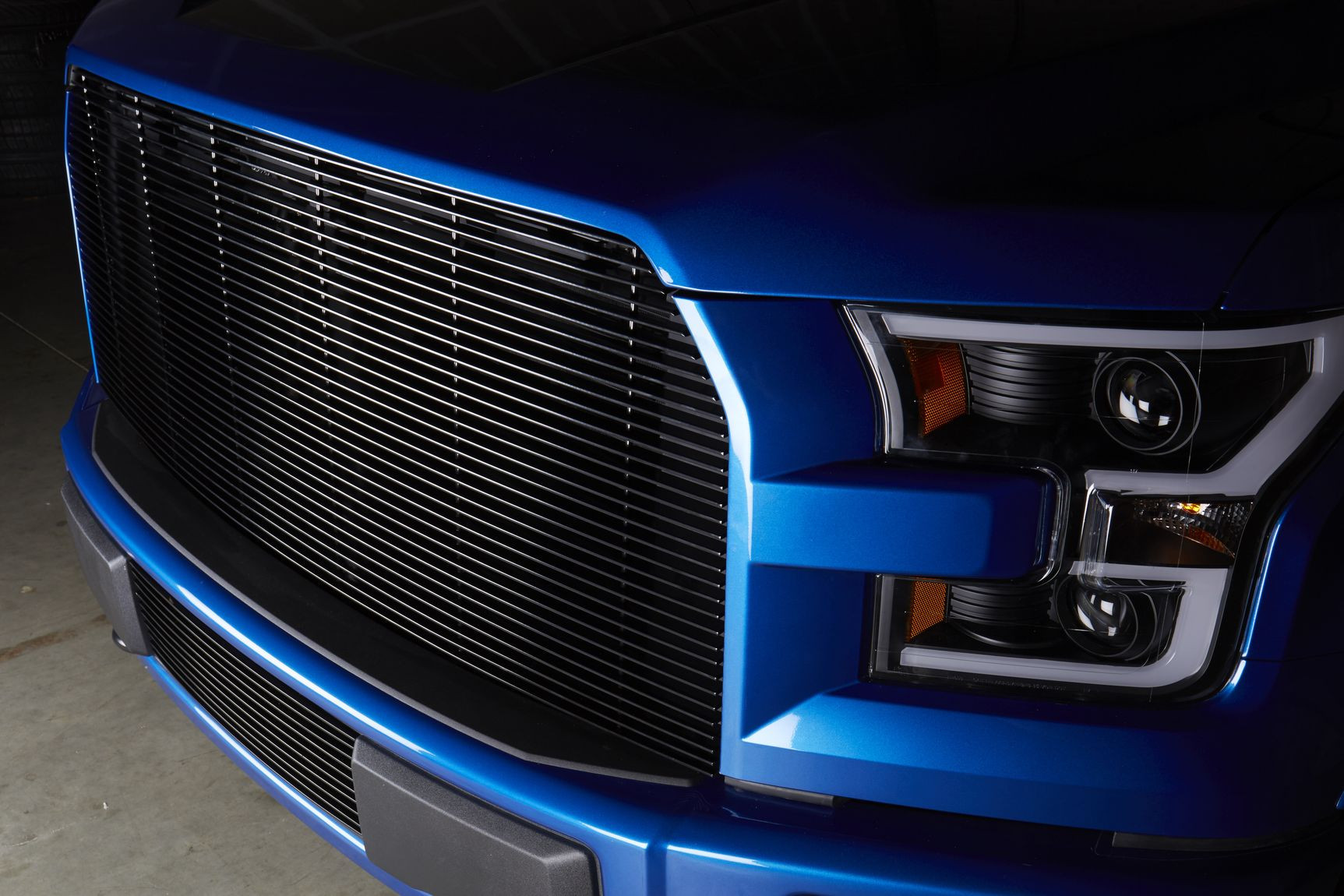 Blue Lifted Ford F-150 with Aftermarket Billet Grille - Photo by CARiD