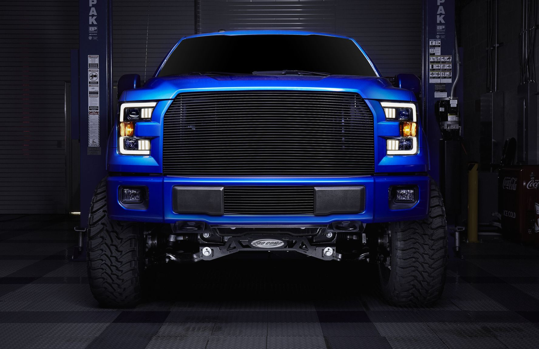 Blue Lifted Ford F-150 with Billet Bumper Grille - Photo by CARiD