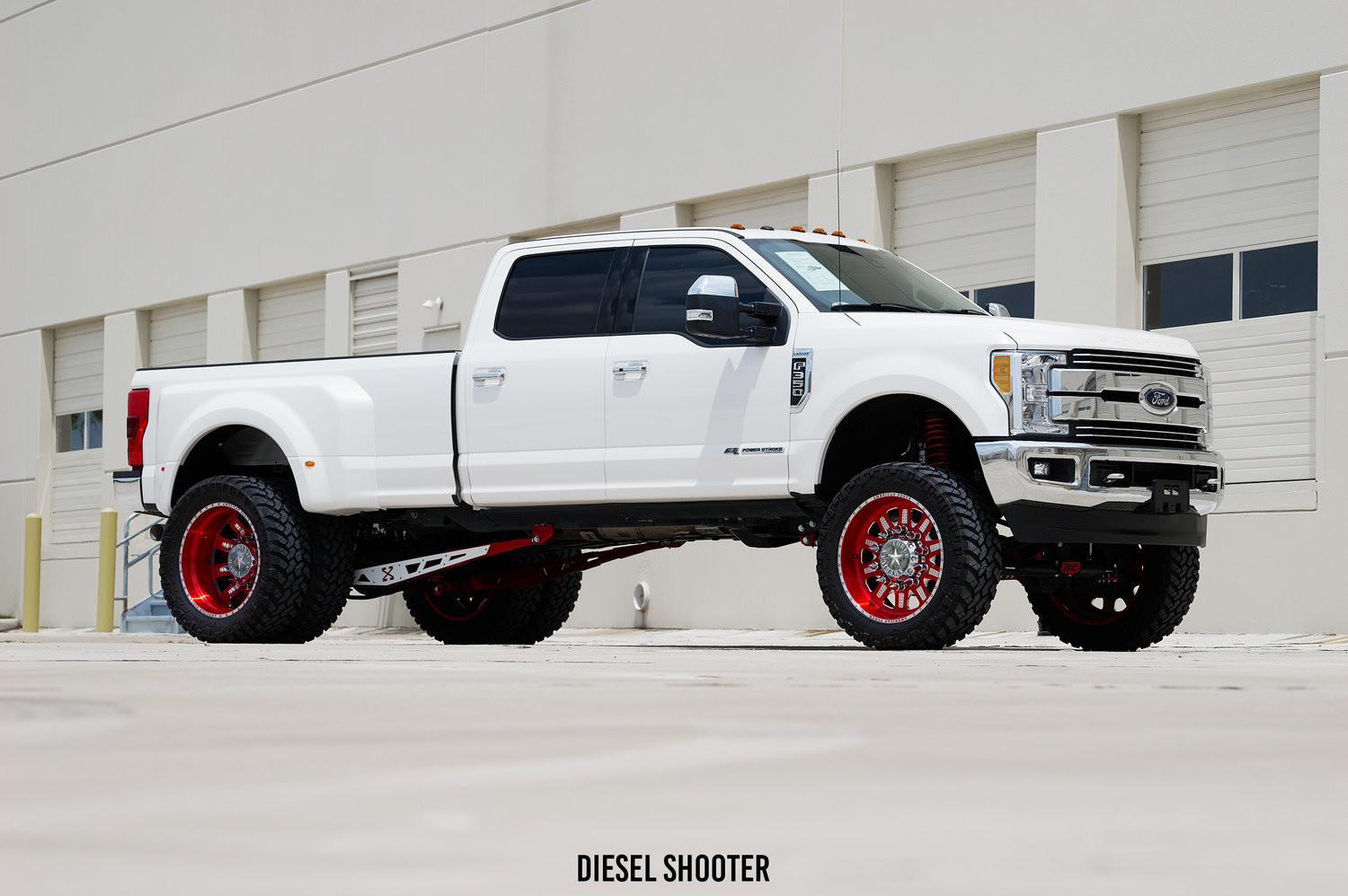 Lifted Ford Powerstroke with AMP Research Running Boards - Photo by Diesel Shooter