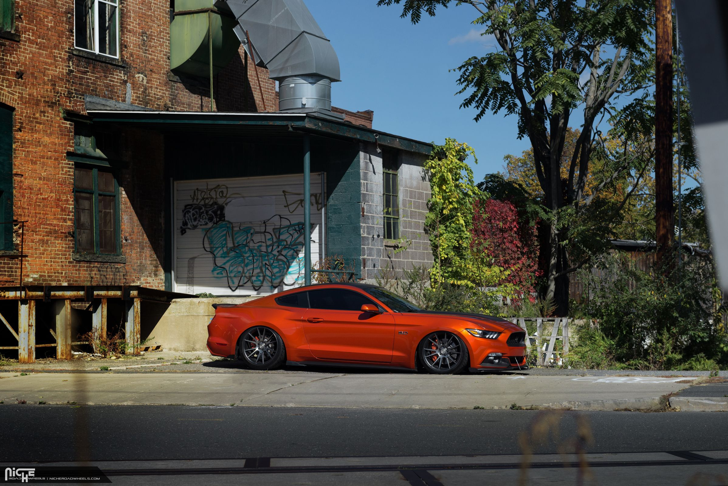 Orange Ford Mustang with Air Lift Suspension Kit - Photo by Niche