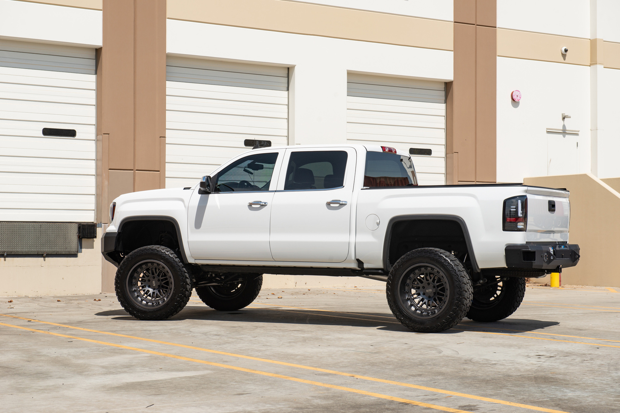 White Lifted GMC Sierra with Retractable Running Boards - Photo by Black Rhino Wheels