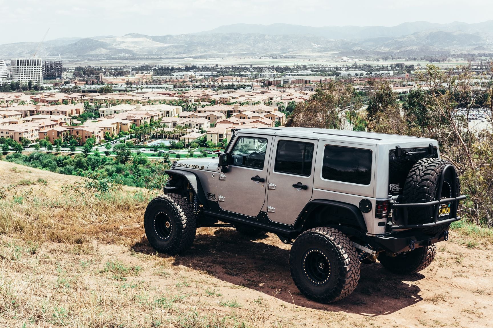 Gray Lifted Jeep Wrangler with Aftermarket Running Boards - Photo by Rebel Off-Road