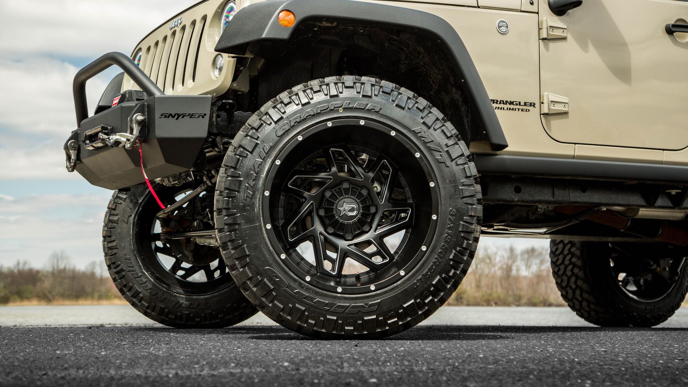 Beige Lifted Jeep Wrangler on Nitto Tires - Photo by CARiD