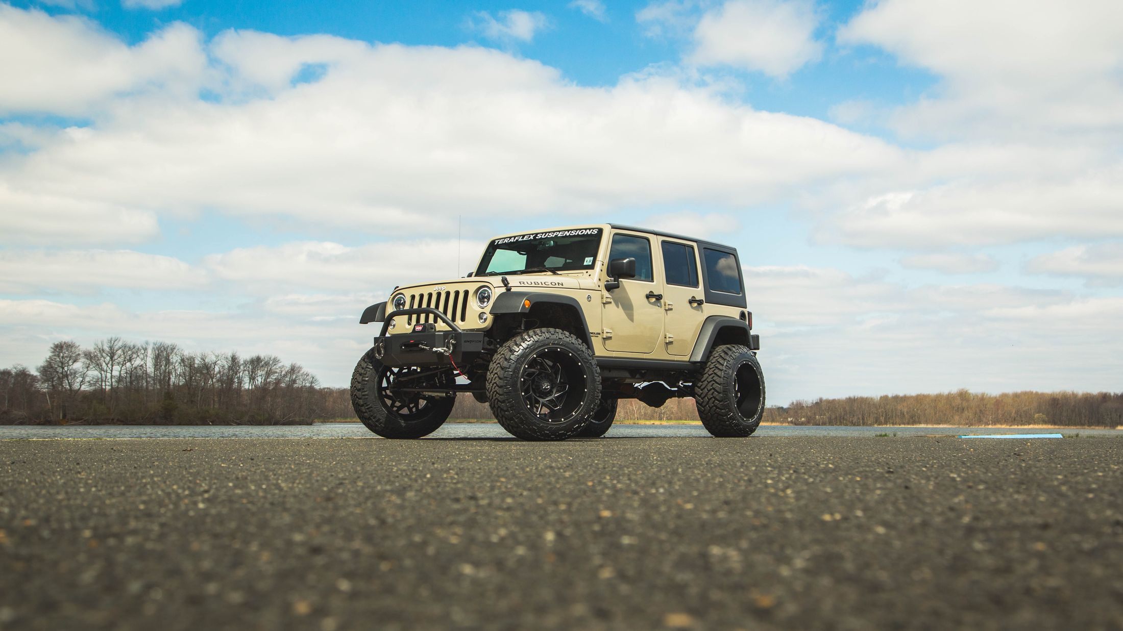 Beige Lifted Jeep Wrangler with Snyper Winch Front Bumper - Photo by CARiD