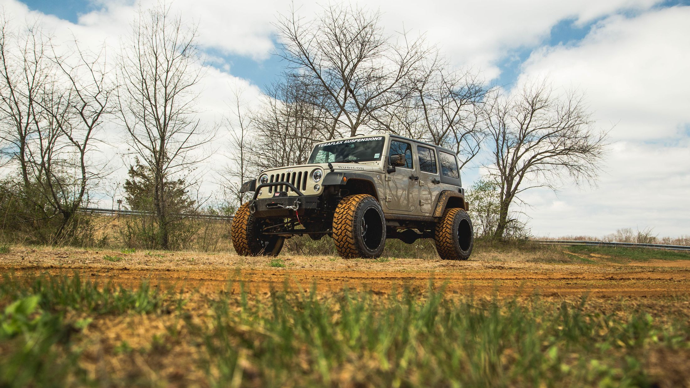 Fox Suspension Shocks on Beige Lifted Jeep Wrangler - Photo by CARiD