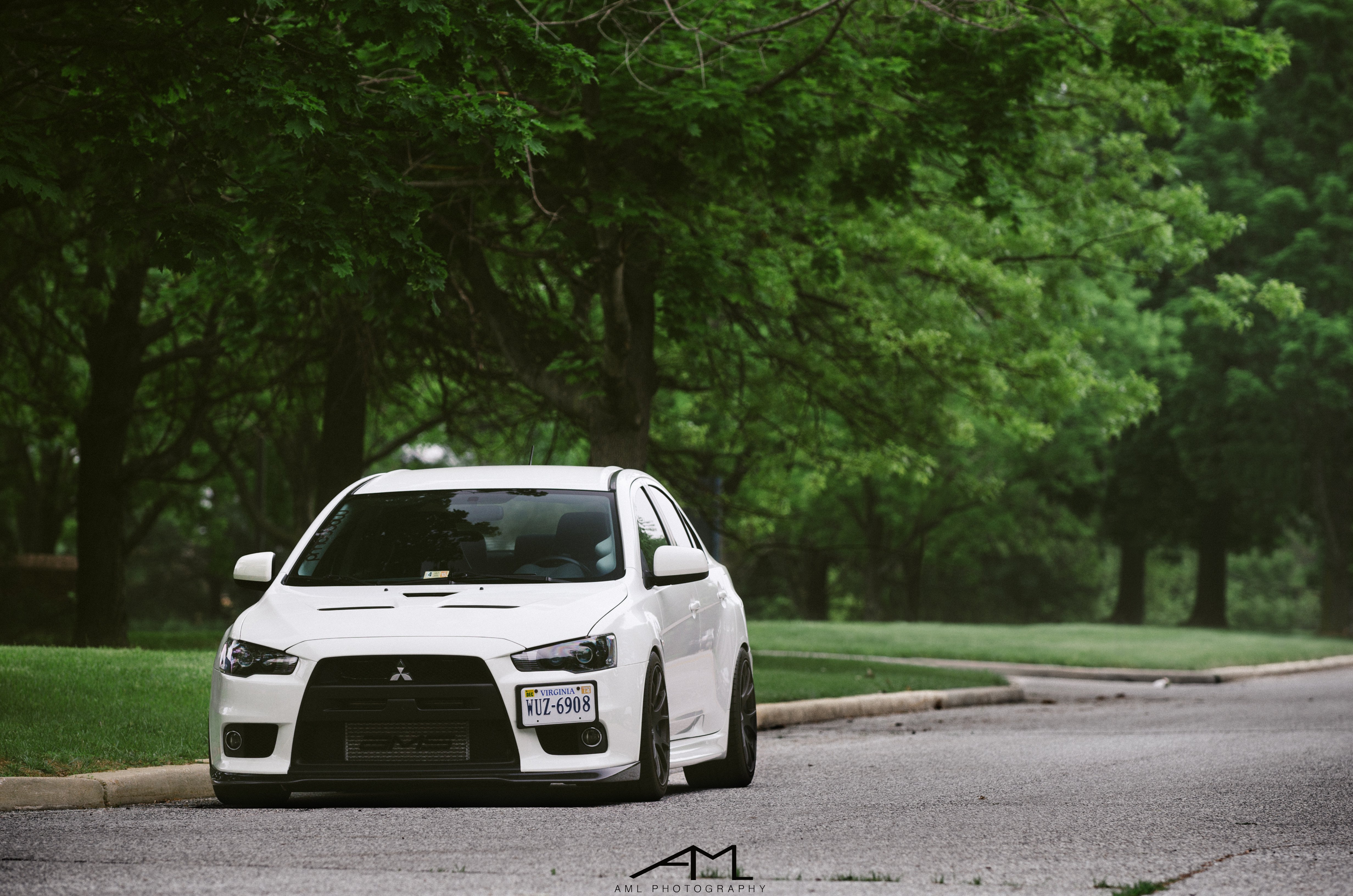 White Mitsubishi Evolution with Dark Smoke Headlights - Photo by Arlen Liverman