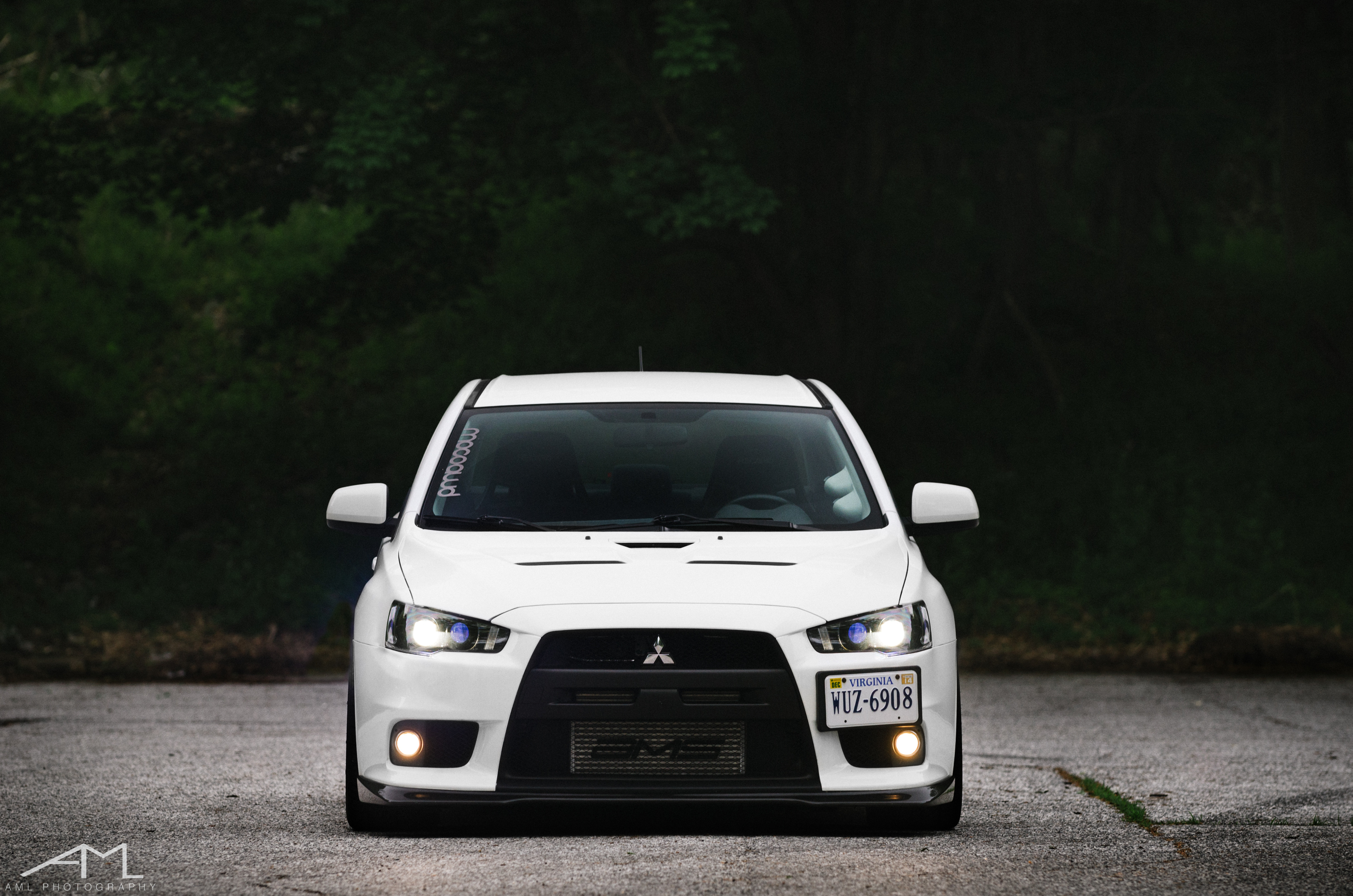 White Mitsubishi Evolution with Aftermarket Front Bumper - Photo by Arlen Liverman