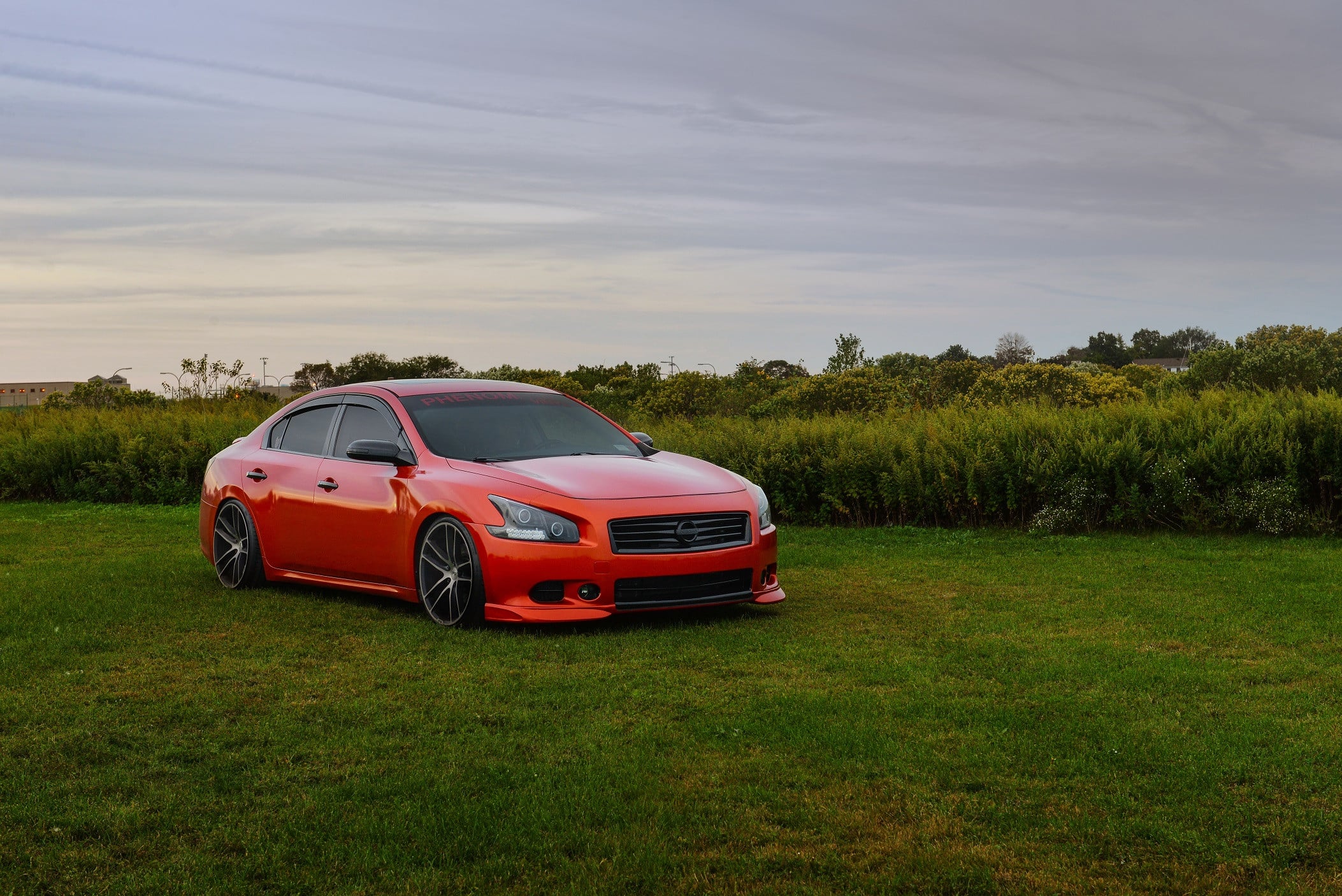 Red Nissan Maxima with Blacked Out Grille - Photo by Niche