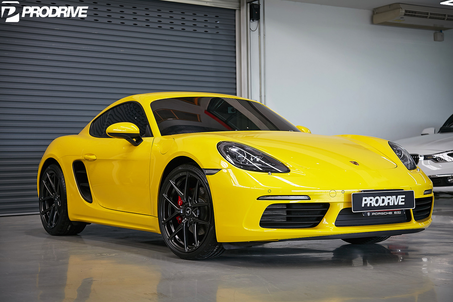 Yellow Porsche Cayman with Aftermarket Front Bumper - Photo by Vorstiner
